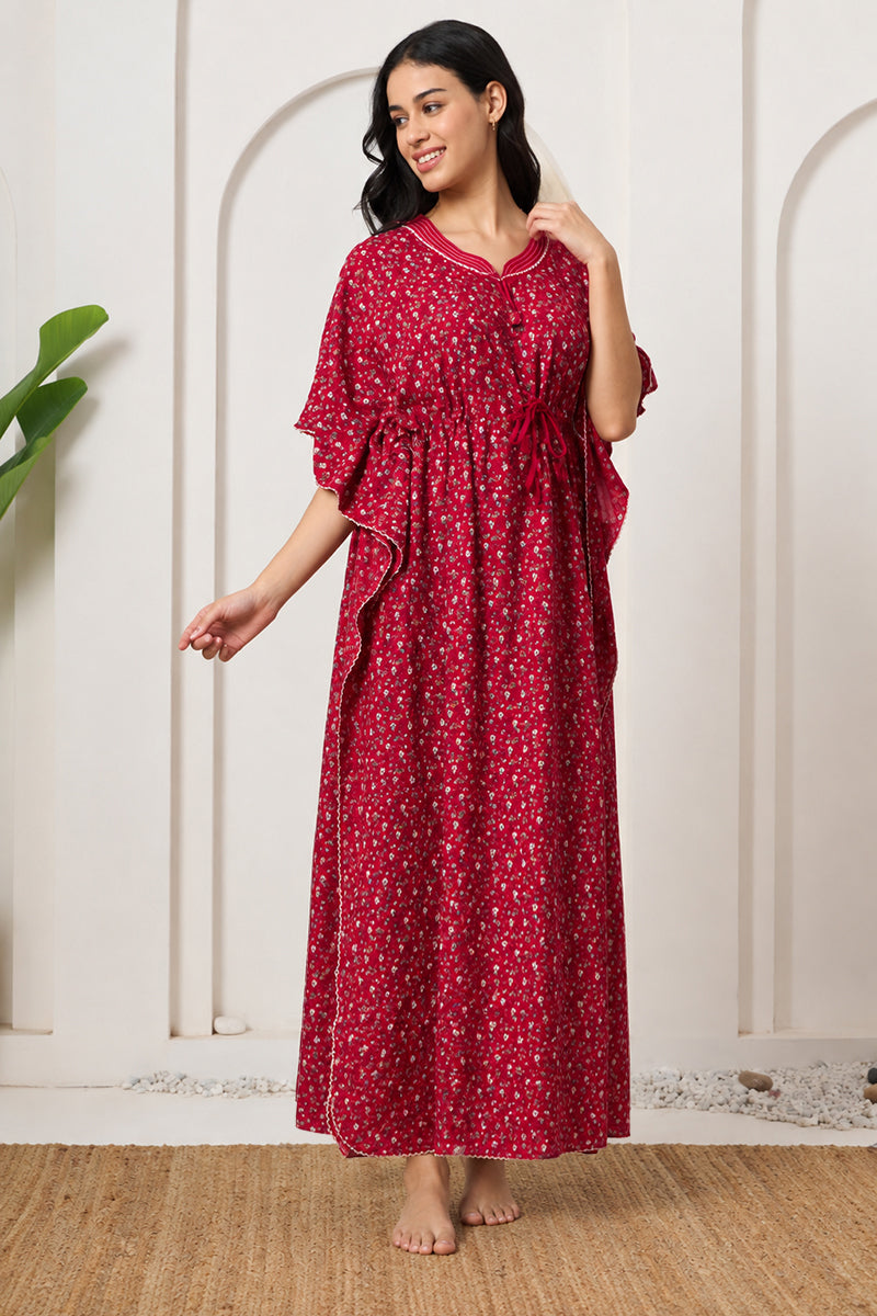 Woman posing sideways in a red floral kaftan