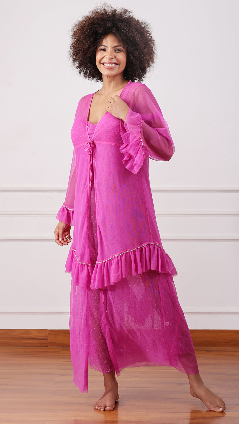 Woman wearing a sheer pink mesh cami dress, cold-shoulder sleeves