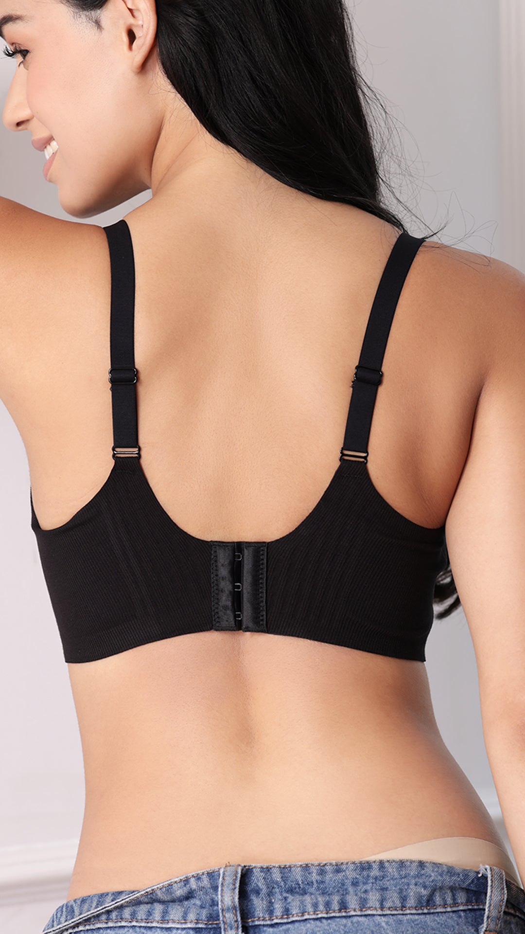 Back view of black wireless bra showing adjustable straps and hook closure