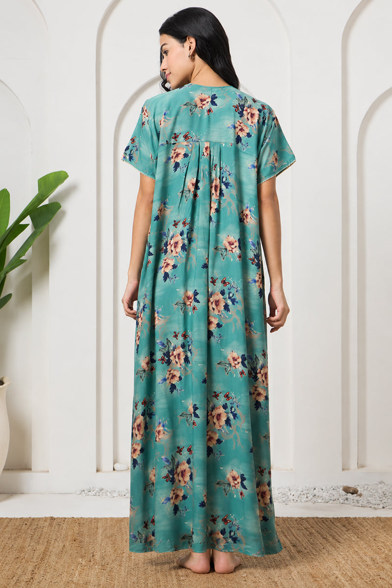 Back view of a woman in a teal floral nightgown