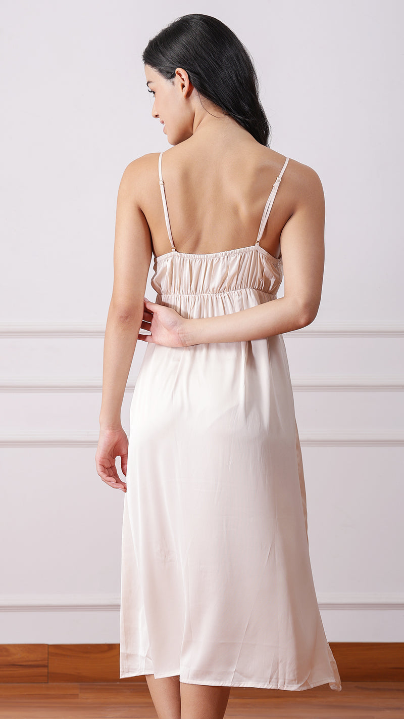 Back view of woman wearing beige satin lace nightgown
