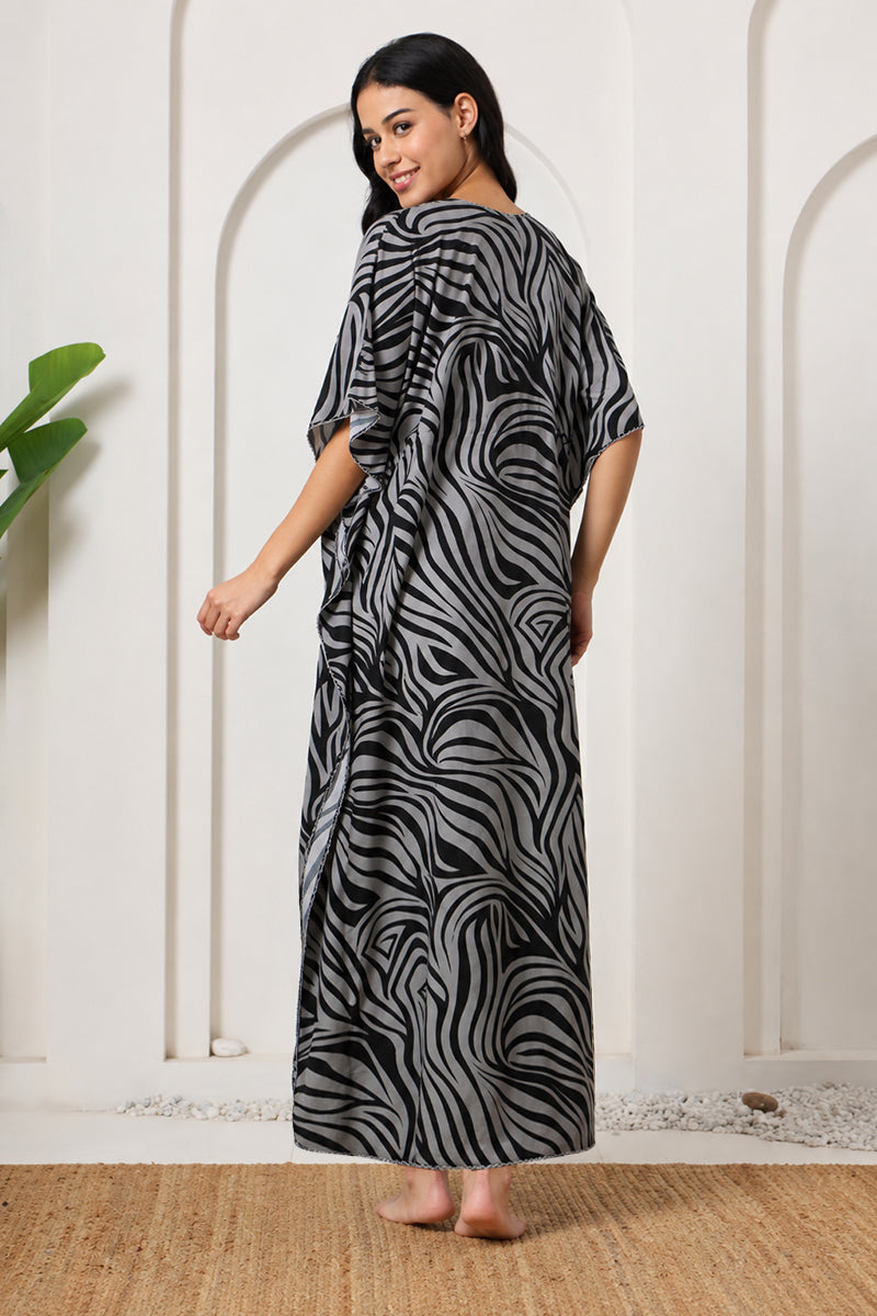 Back view of a woman in a black and grey zebra print kaftan