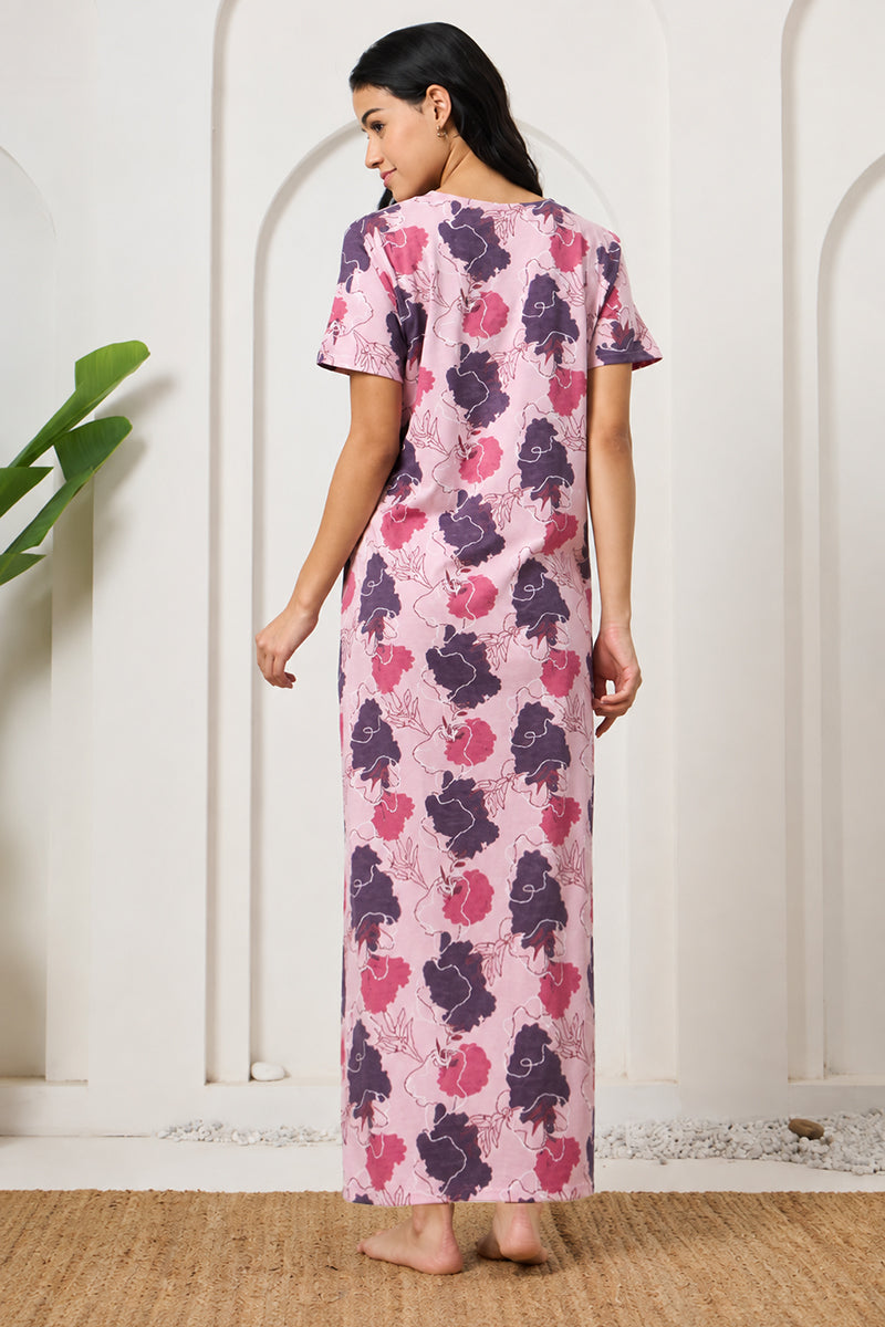 Back view of a woman wearing a pink and purple floral print maxi nightdress