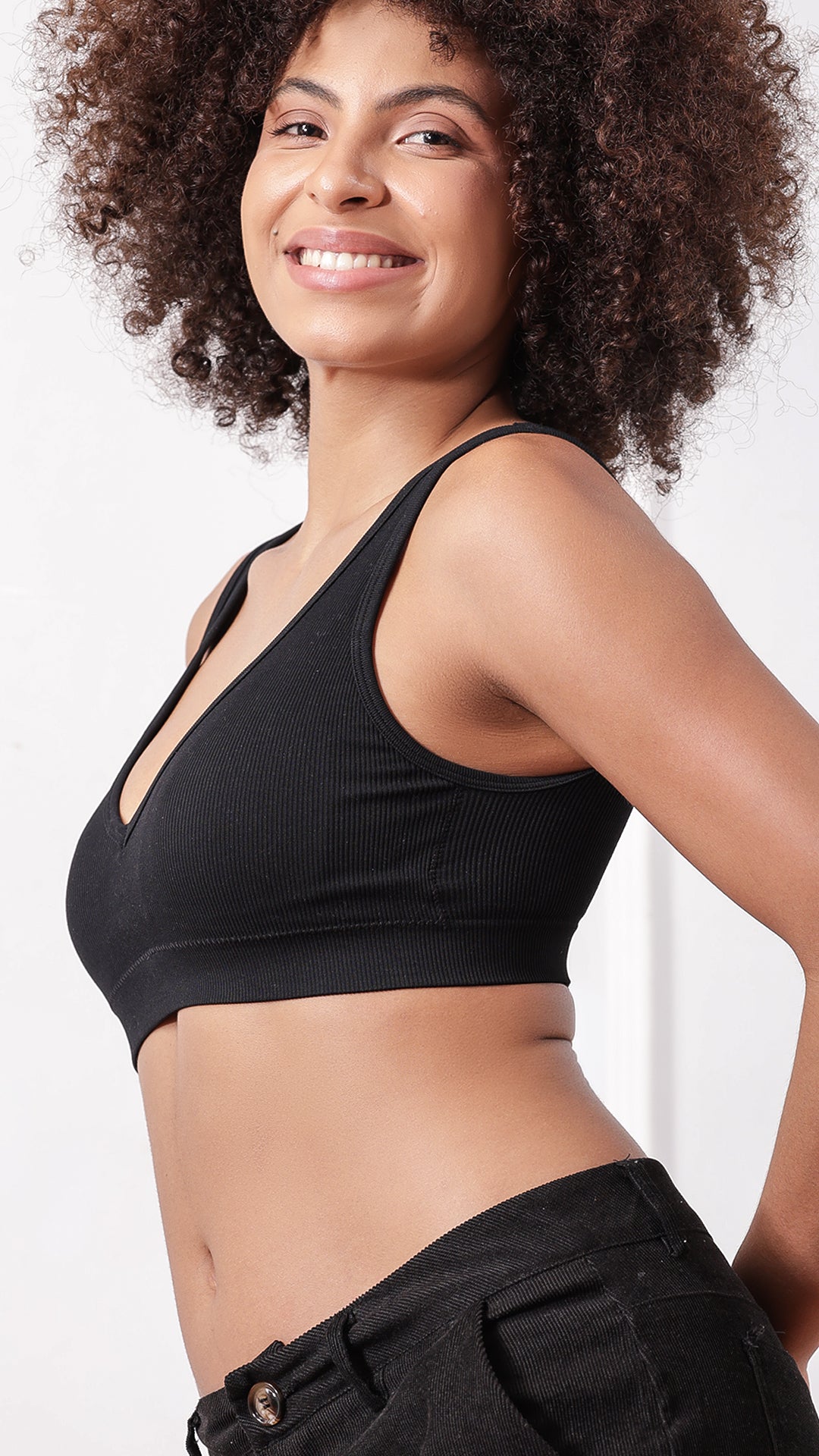 Side view of woman wearing black ribbed padded bra