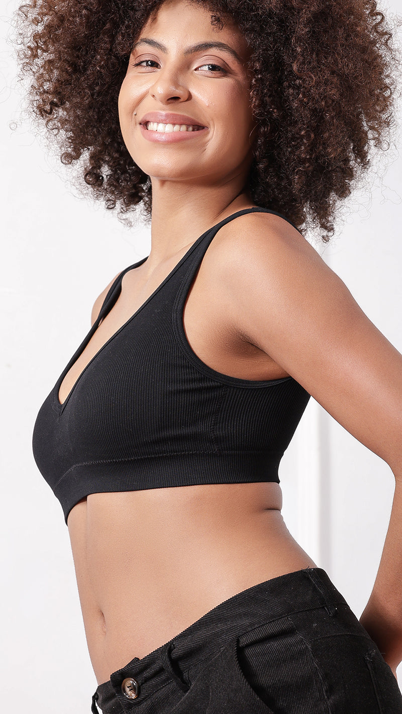 Side view of woman wearing black ribbed padded bra