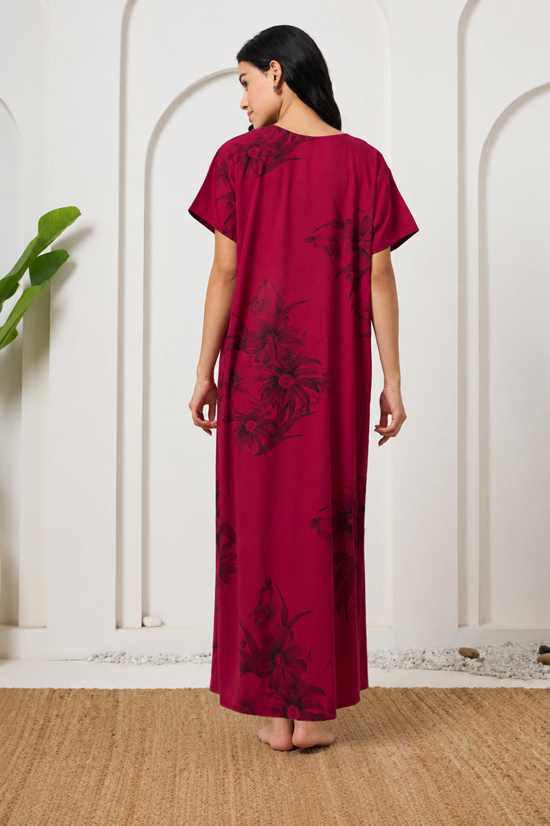 Back view of a woman wearing a maroon floral maxi nightgown