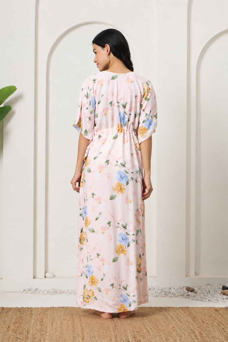 Back view of a woman wearing a pink floral kaftan