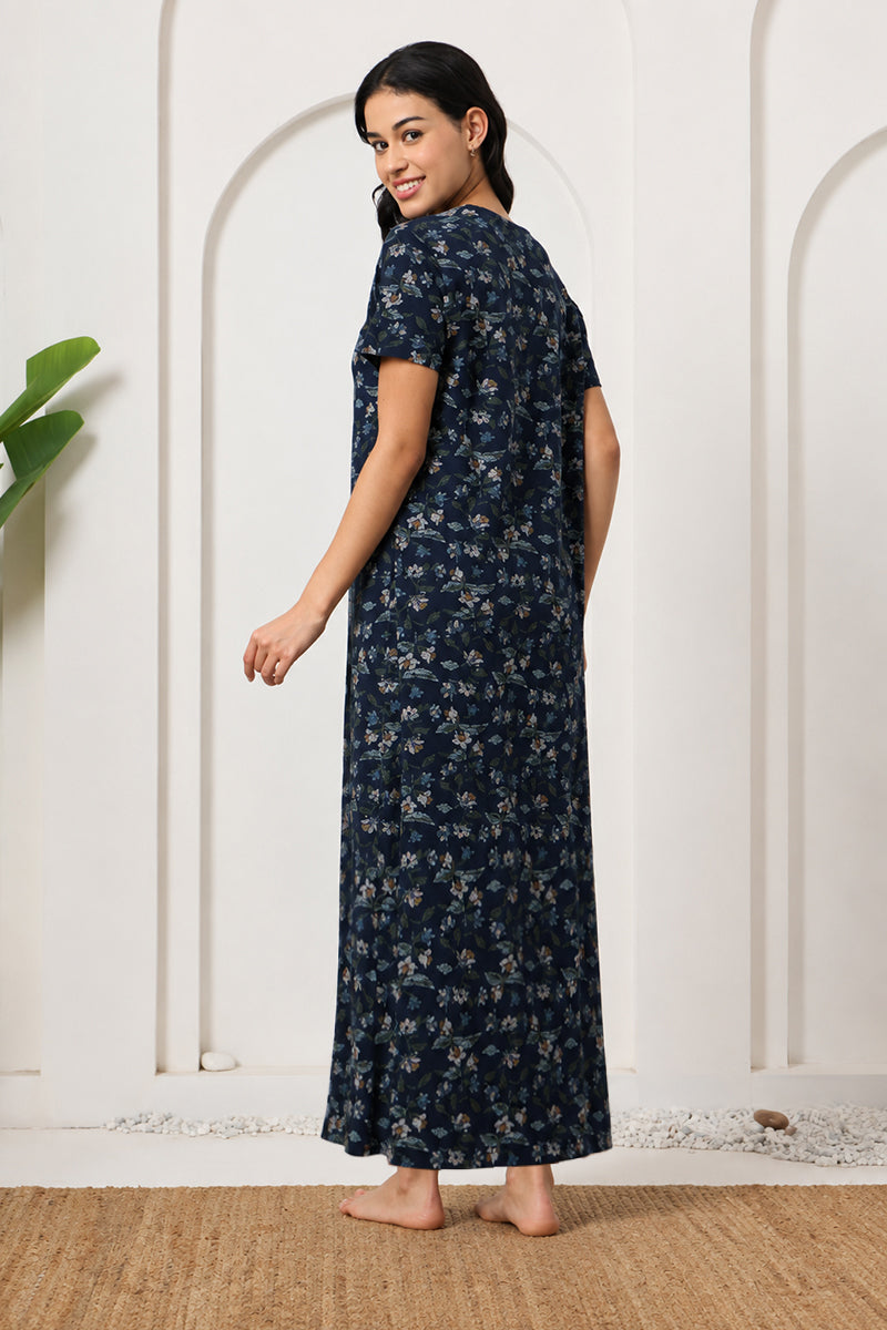 Back view of a woman wearing a navy floral print maxi nightdress