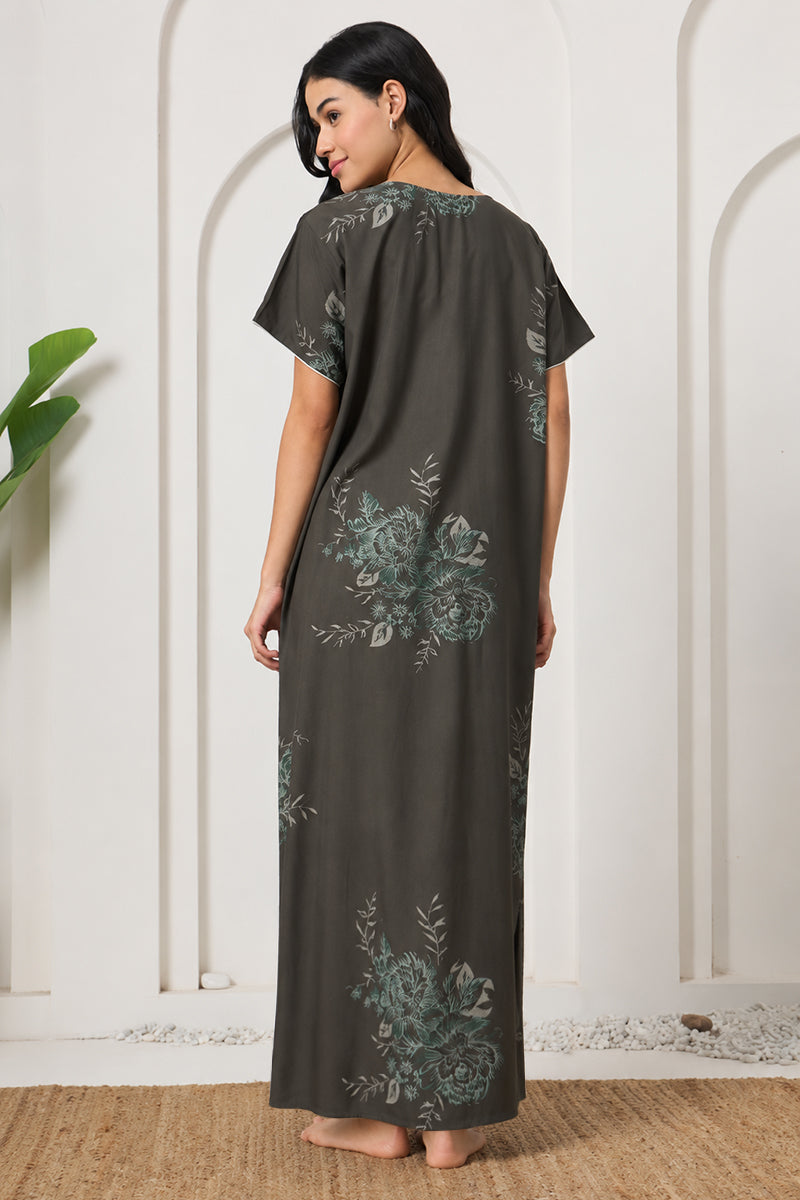 Back view of a woman wearing an olive green floral print nightgown