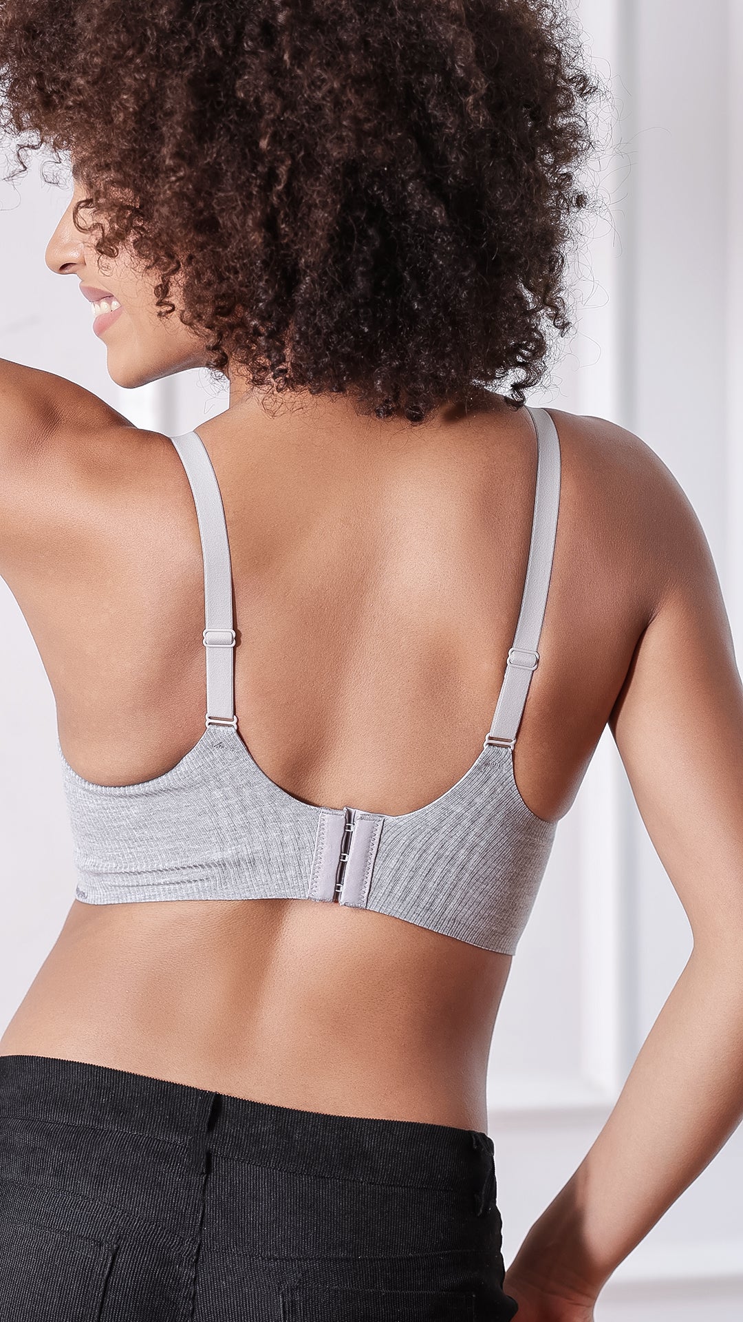 Back view of grey ribbed bra showing adjustable straps and 3-hook closure