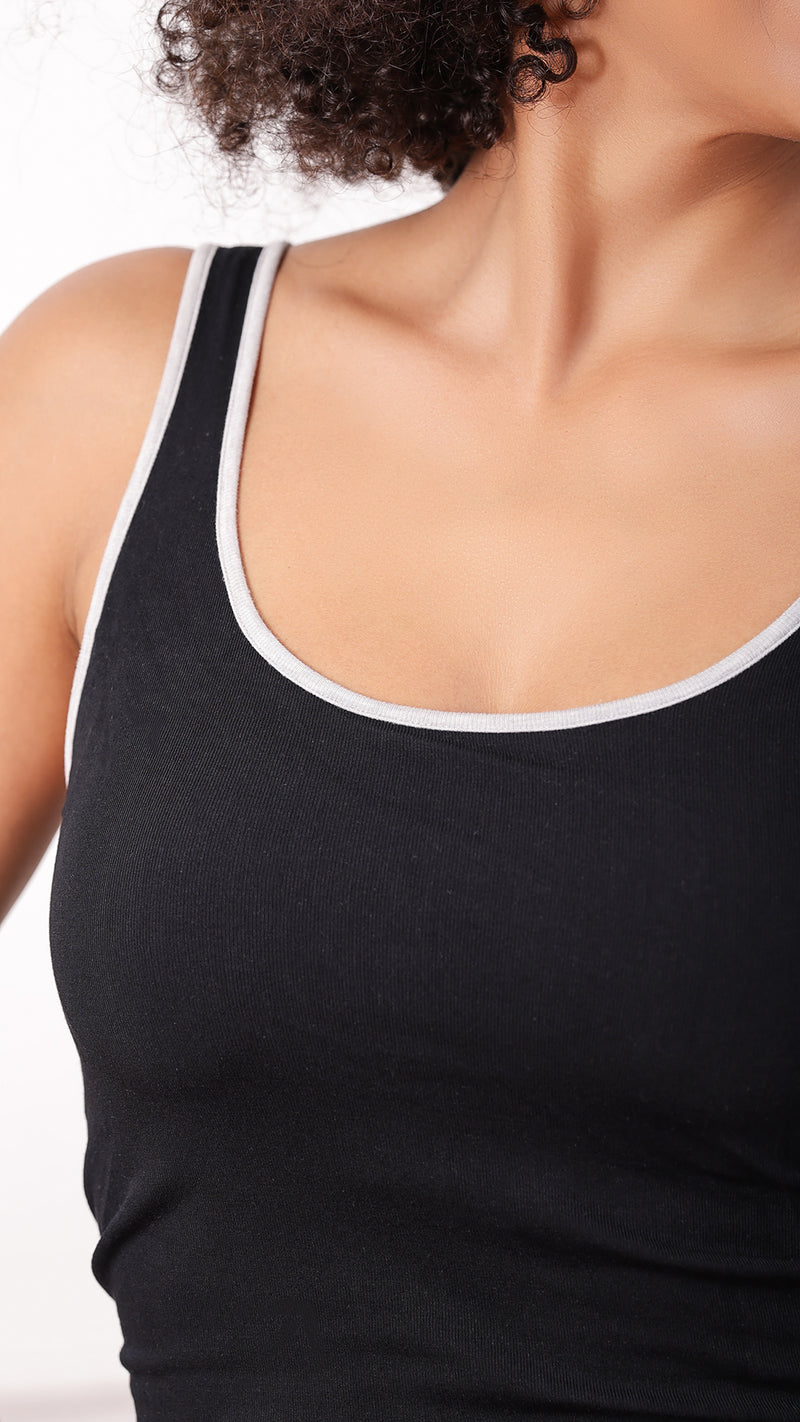 Close-up of contrast-trim neckline on black tank top