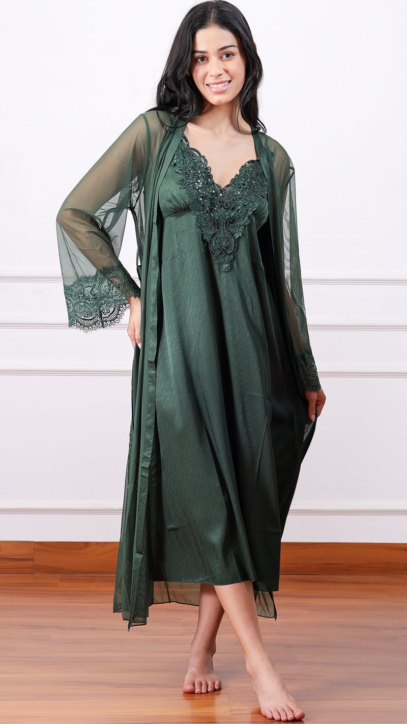 Woman wearing dark green satin nightdress with sheer lace-cuff robe, front view