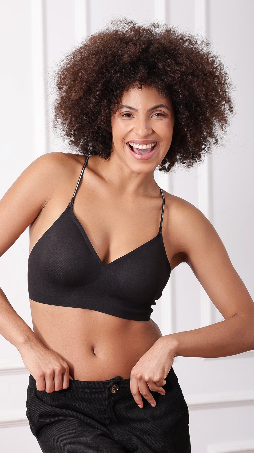 Model laughing in black bralette, front view
