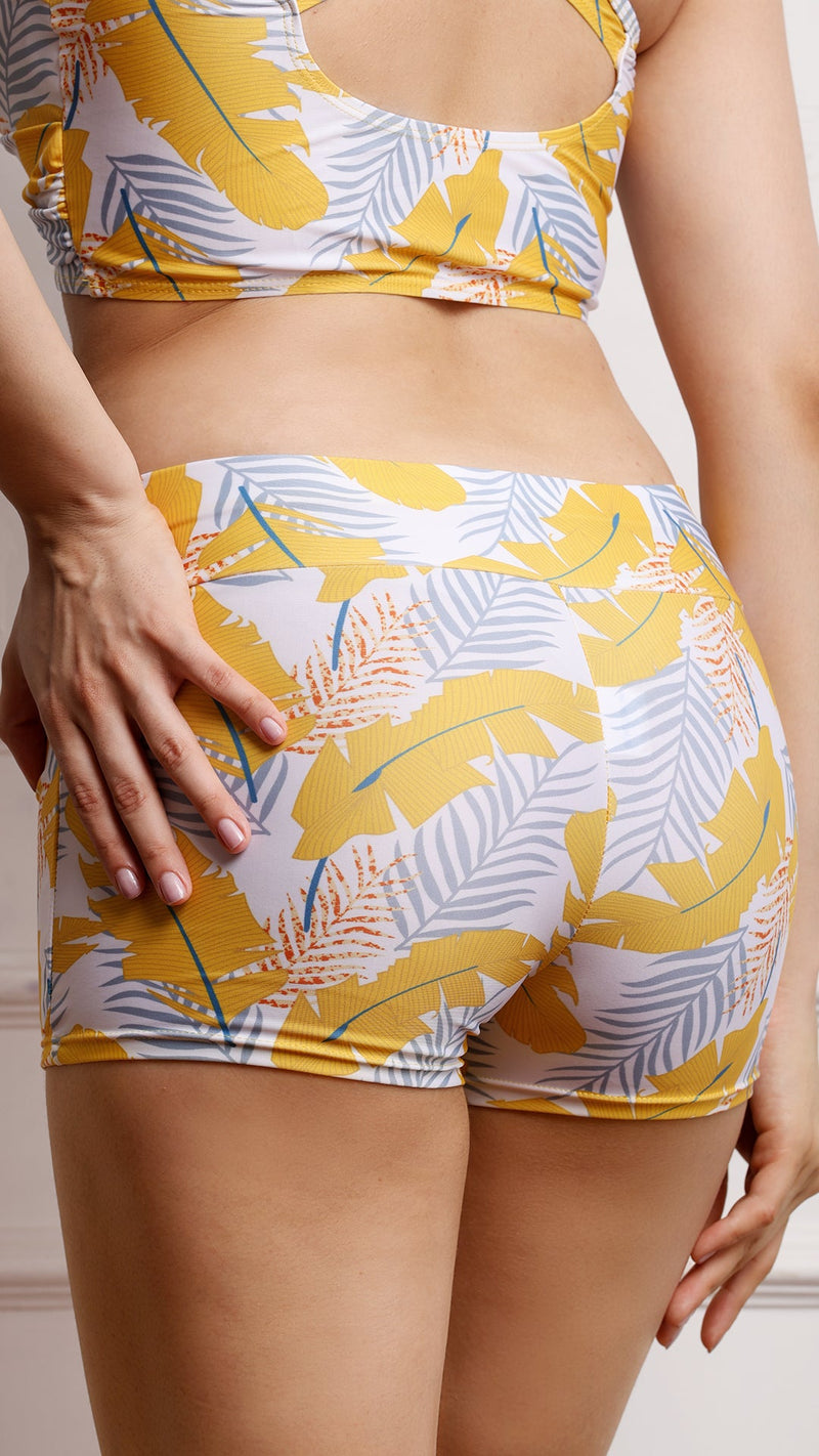 Close-up back view of tropical print shorts on model