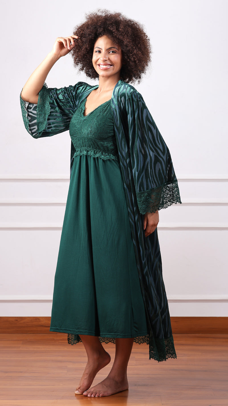 Woman posing in emerald green nightdress with zebra-print lace-trim robe
