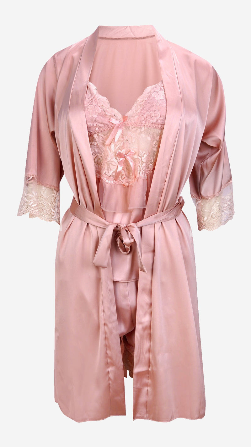 Studio display of a three-piece blush pink satin bridal nightwear set featuring a tied robe and lace cami.