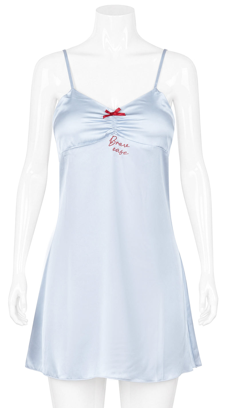 Mannequin display of pale blue satin chemise with red bow detail