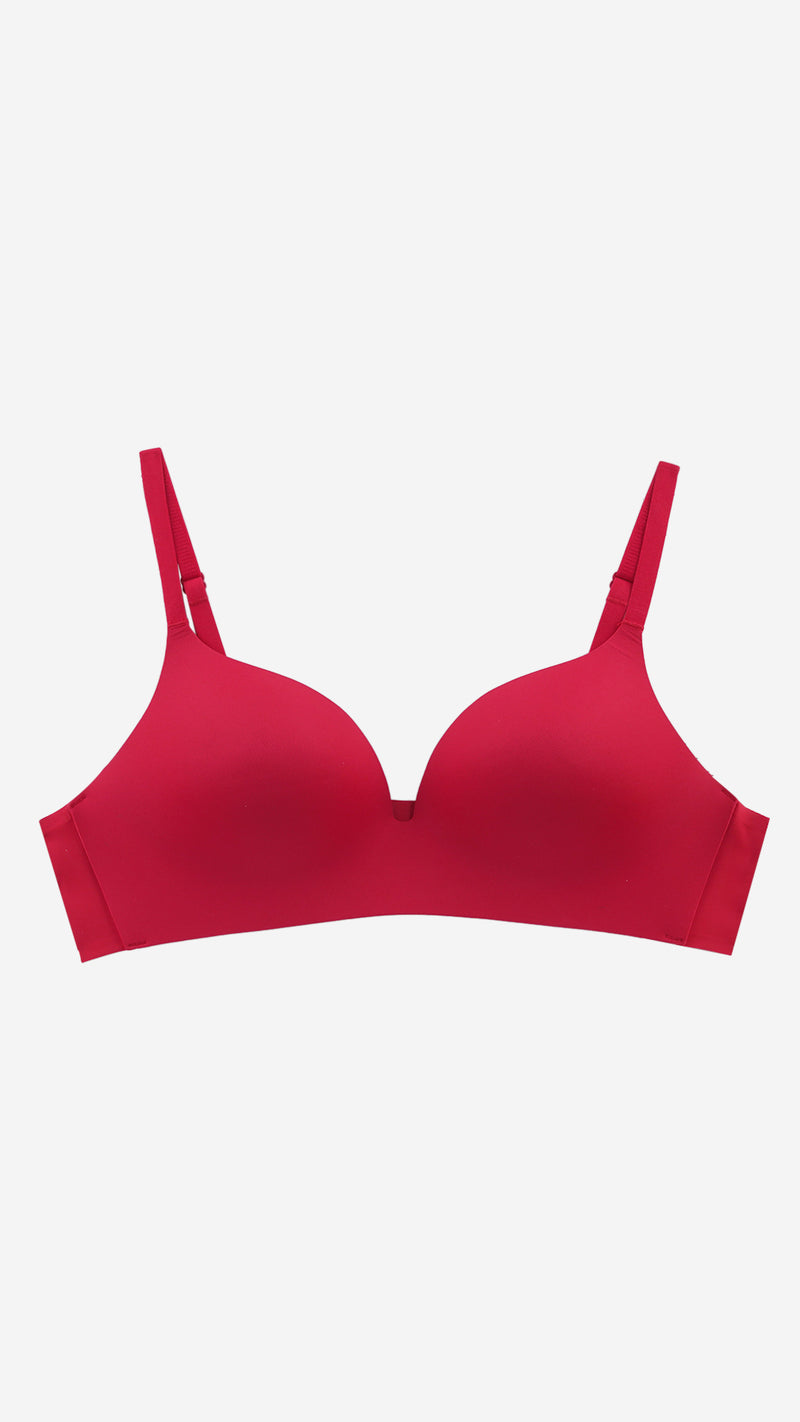 Red seamless push-up T-shirt bra on white background, front flat lay