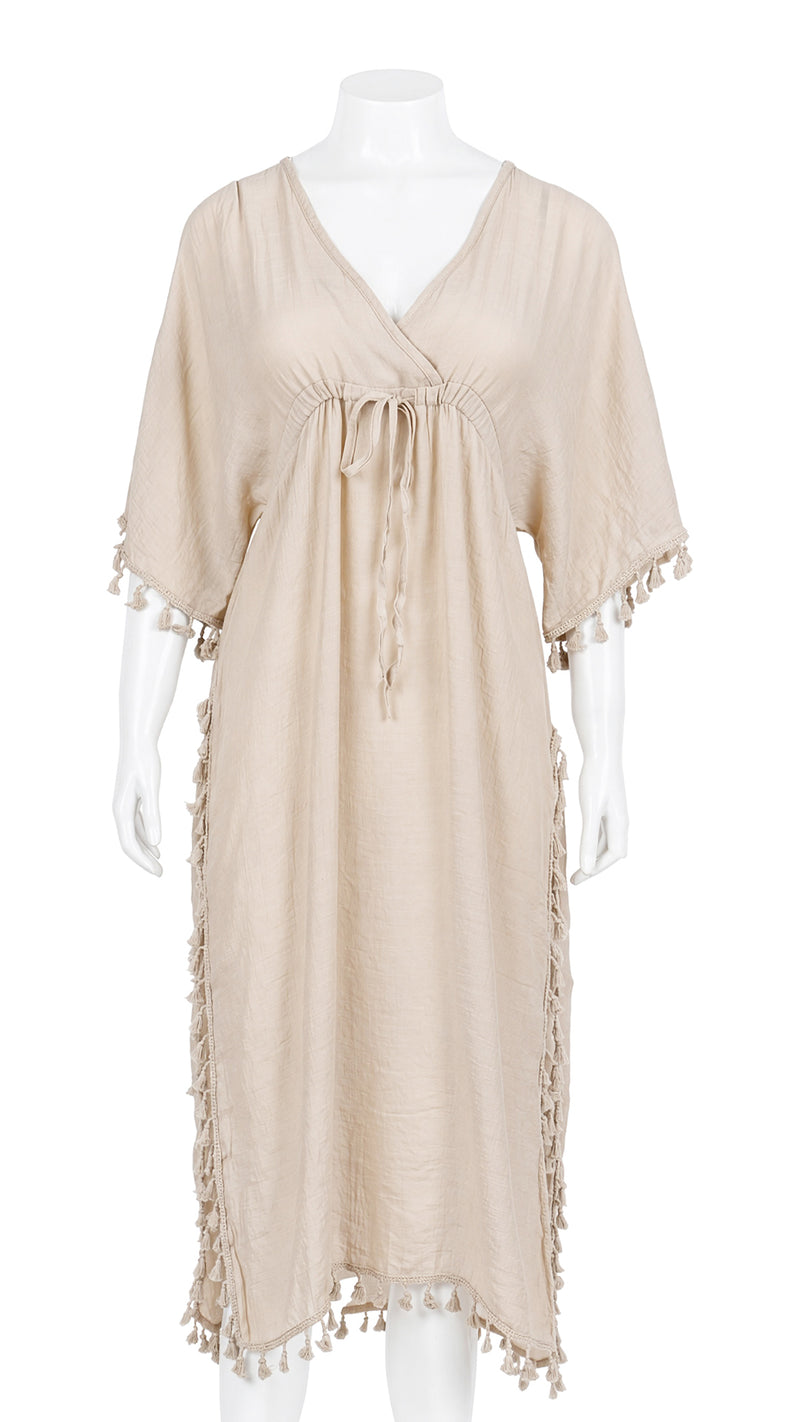 Front view of beige tasselled kaftan dress on mannequin