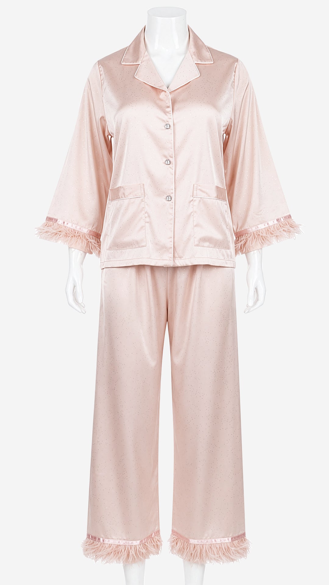 Close-up product shot of blush pink satin pyjama set feather cuff detail on mannequin