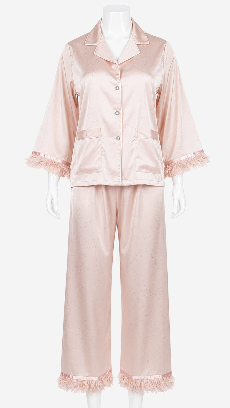 Close-up product shot of blush pink satin pyjama set feather cuff detail on mannequin