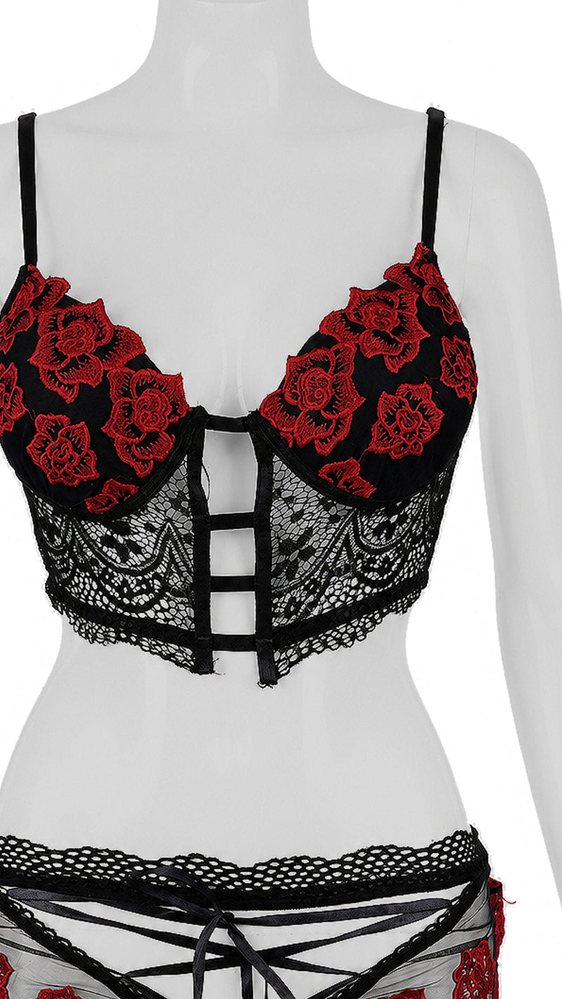 Black lace bra with red floral embroidery on mannequin, close-up front view