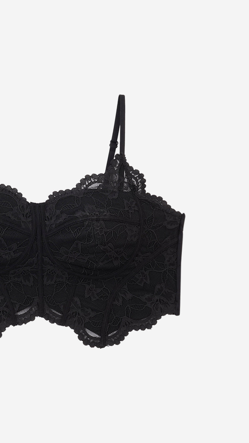 Close-up product shot of lace corset bra cup and strap detail