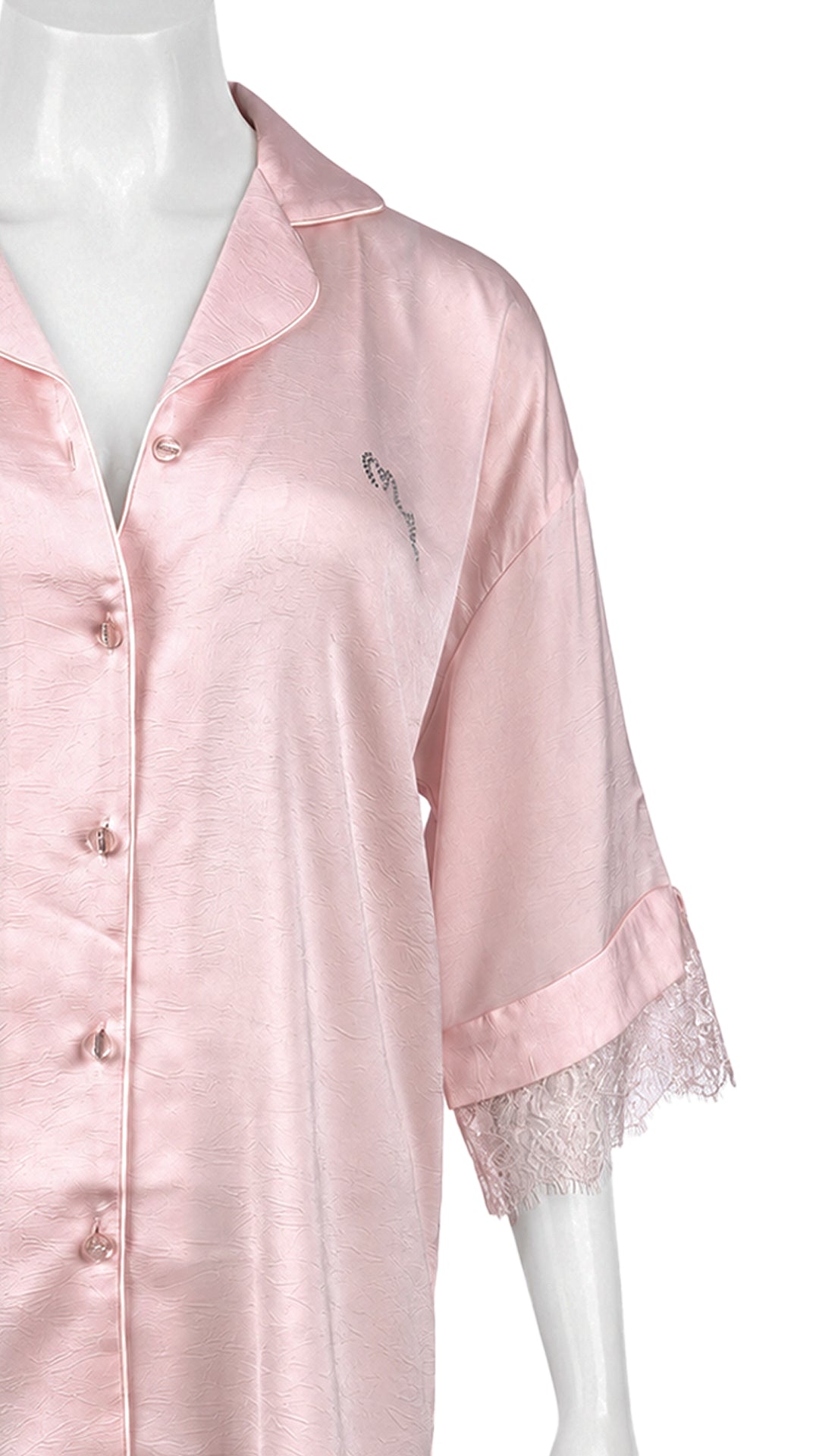 Pink satin sleep shirt with lace trim on mannequin, close-up front view