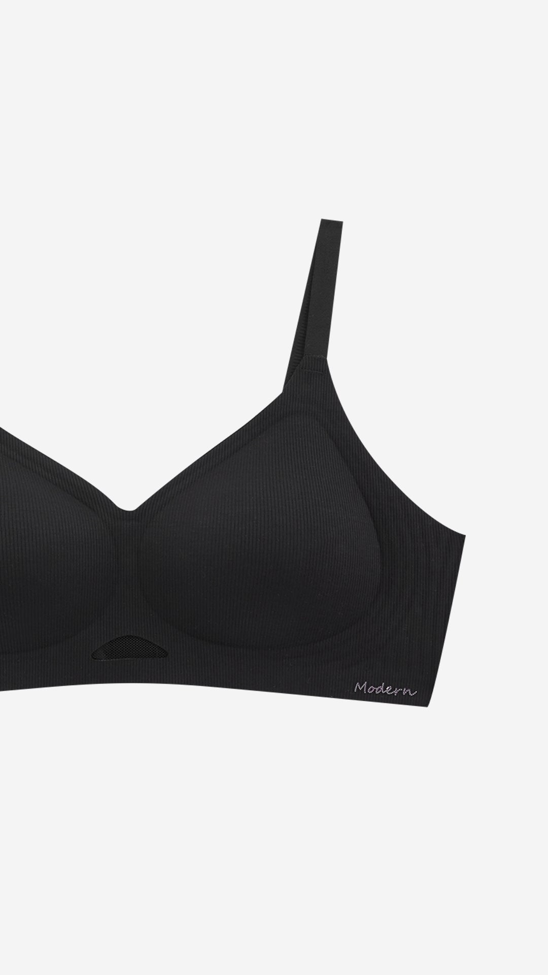 Close-up of black wireless bra cup and strap on white background