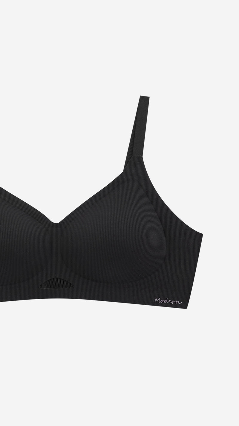 Close-up of black wireless bra cup and strap on white background