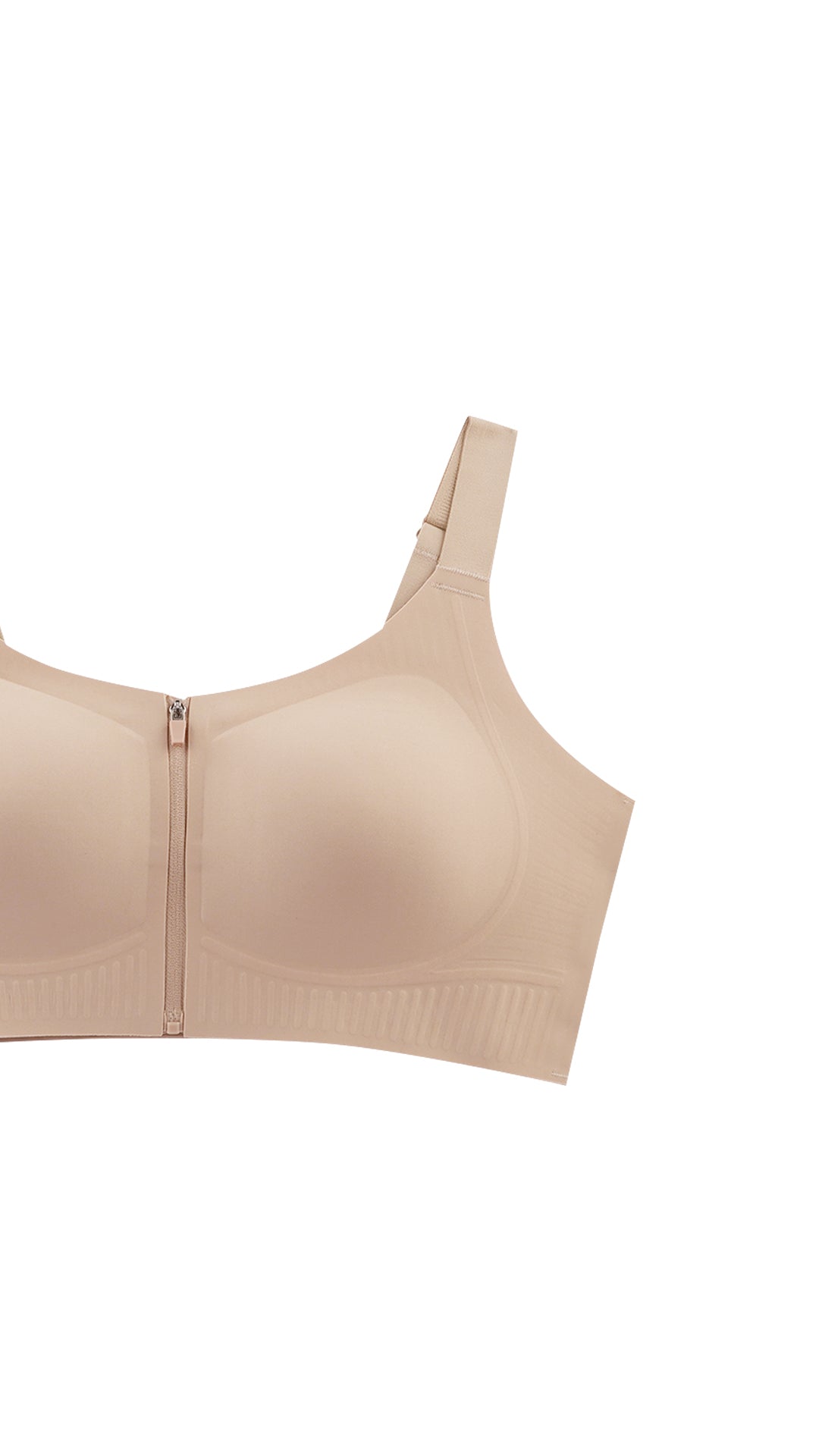 Close-up product shot of beige sports bra strap and embossed cup detail