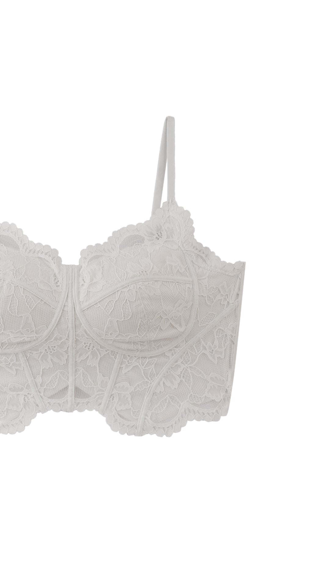 Woman wearing grey racerback bralette with lace trim, front view