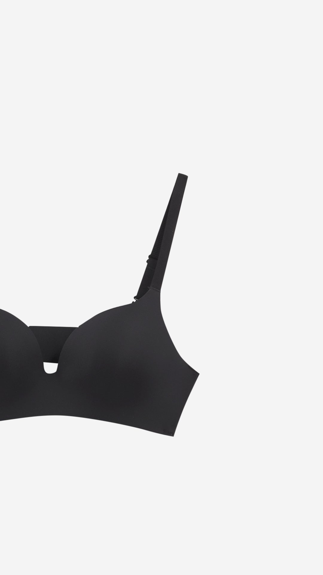 Close-up product shot of black bra strap and cup detail
