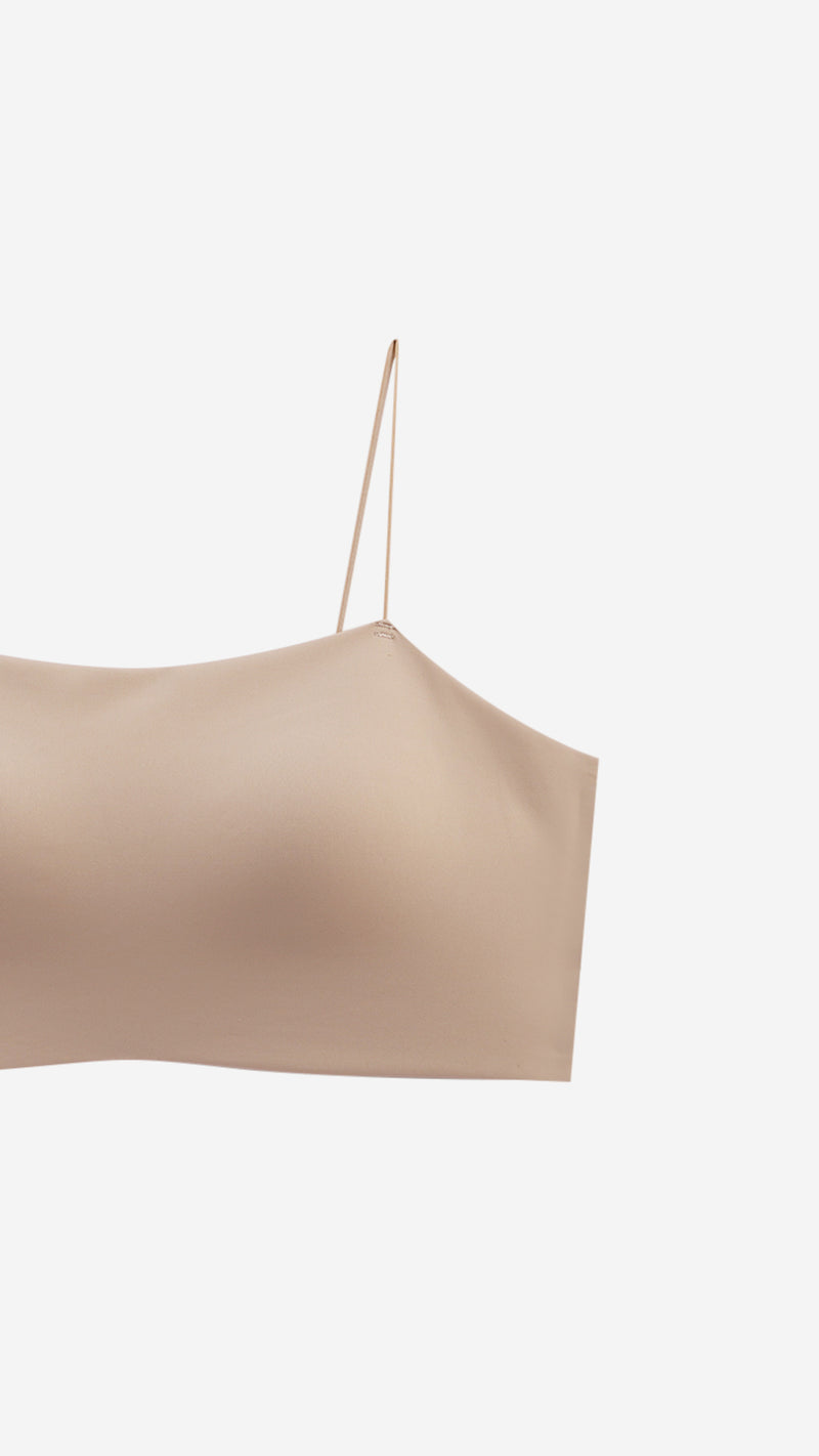 Close-up of beige bralette diamante strap on white background
