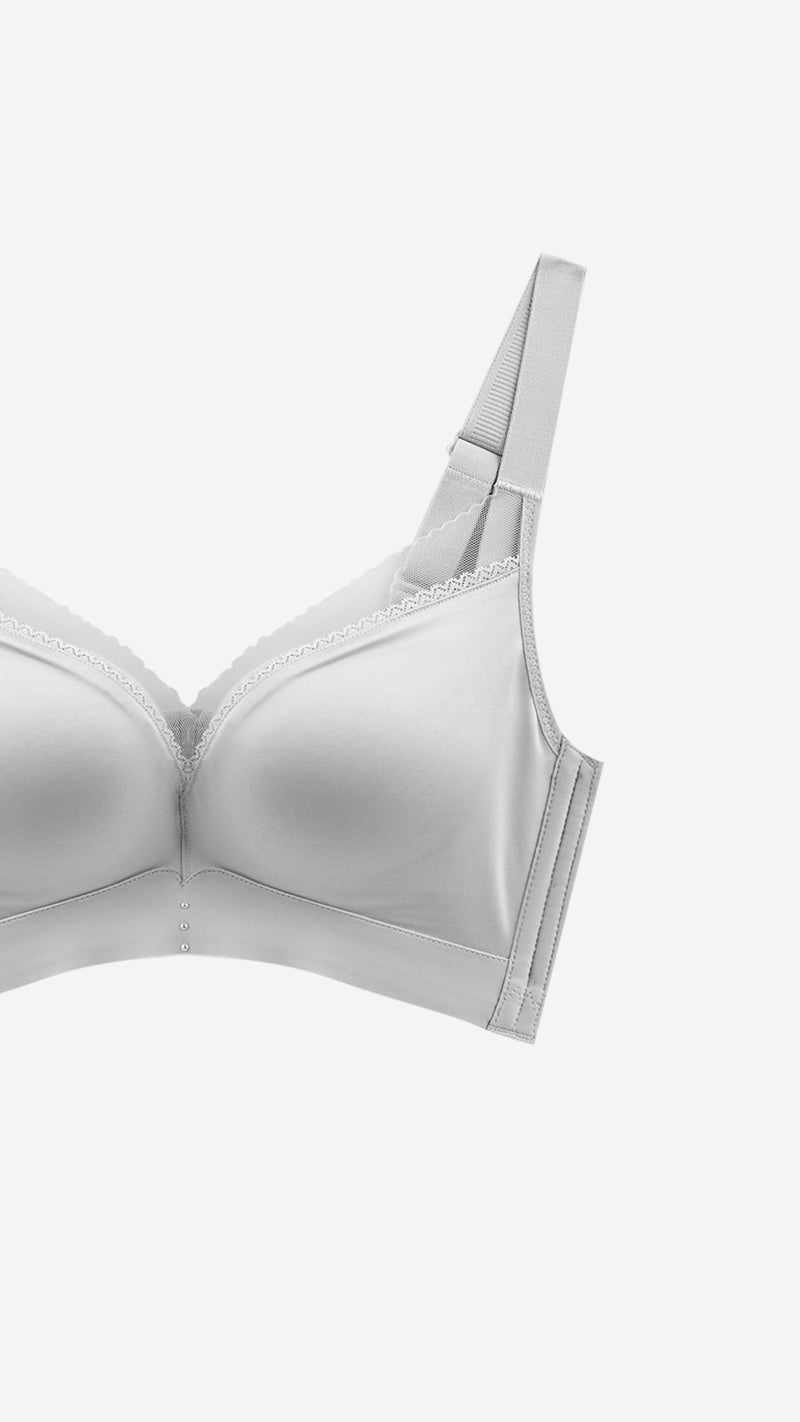 Close-up of white T-shirt bra strap and lace trim on white background