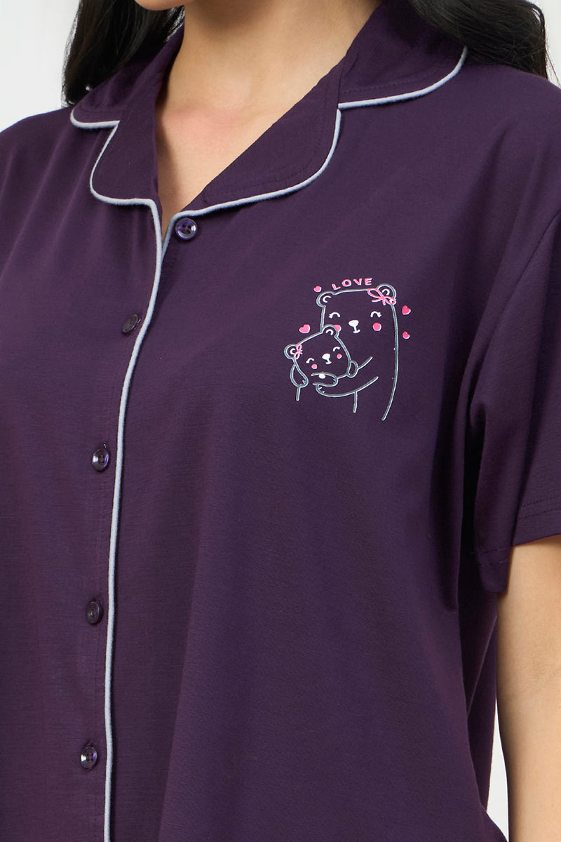 Close up of the bear graphic embroidery on the purple shirt