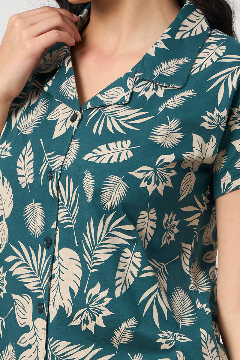 Close up of the notch collar and leaf print detail on the teal shirt