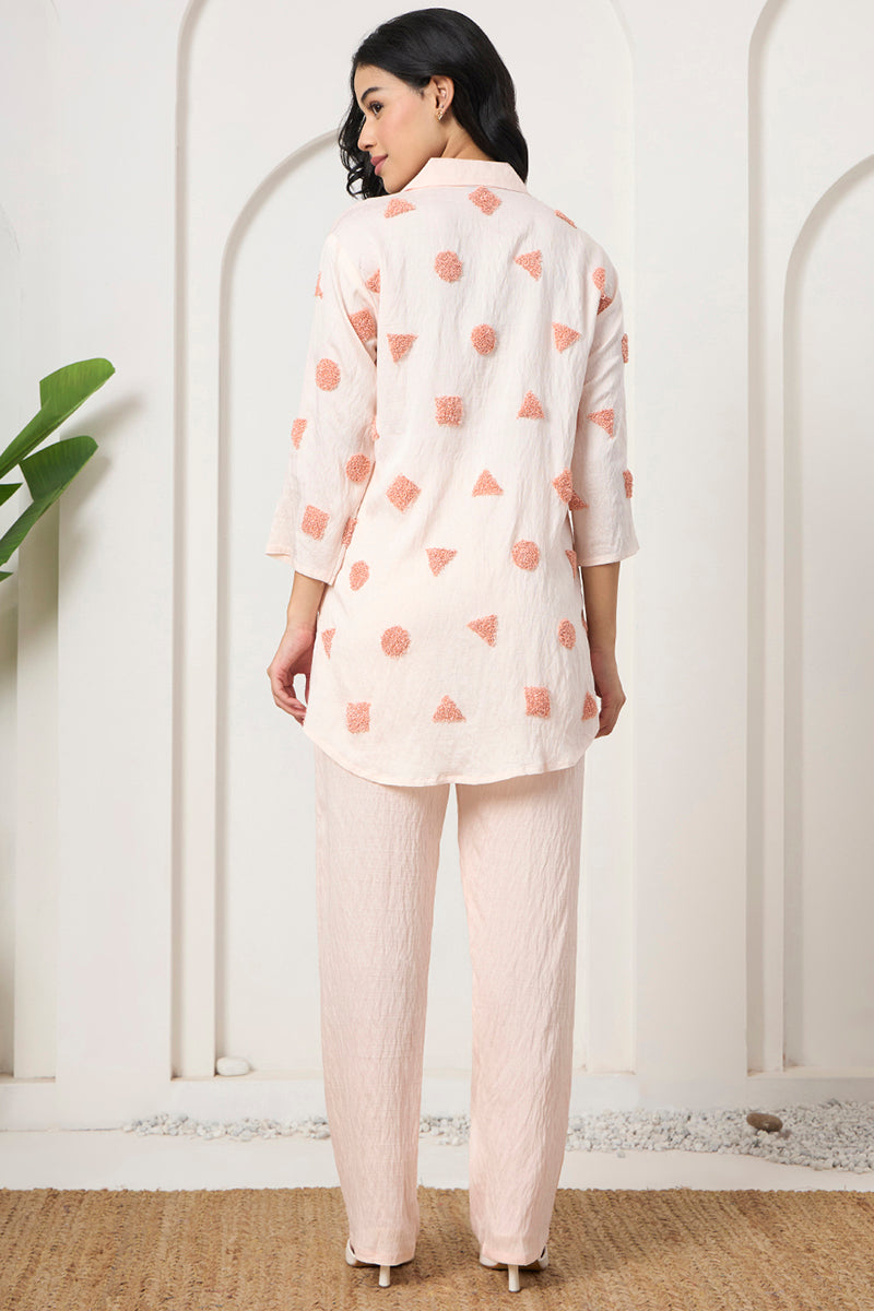 Back view of the peach tunic and pant set showing the textured motif placement across the back