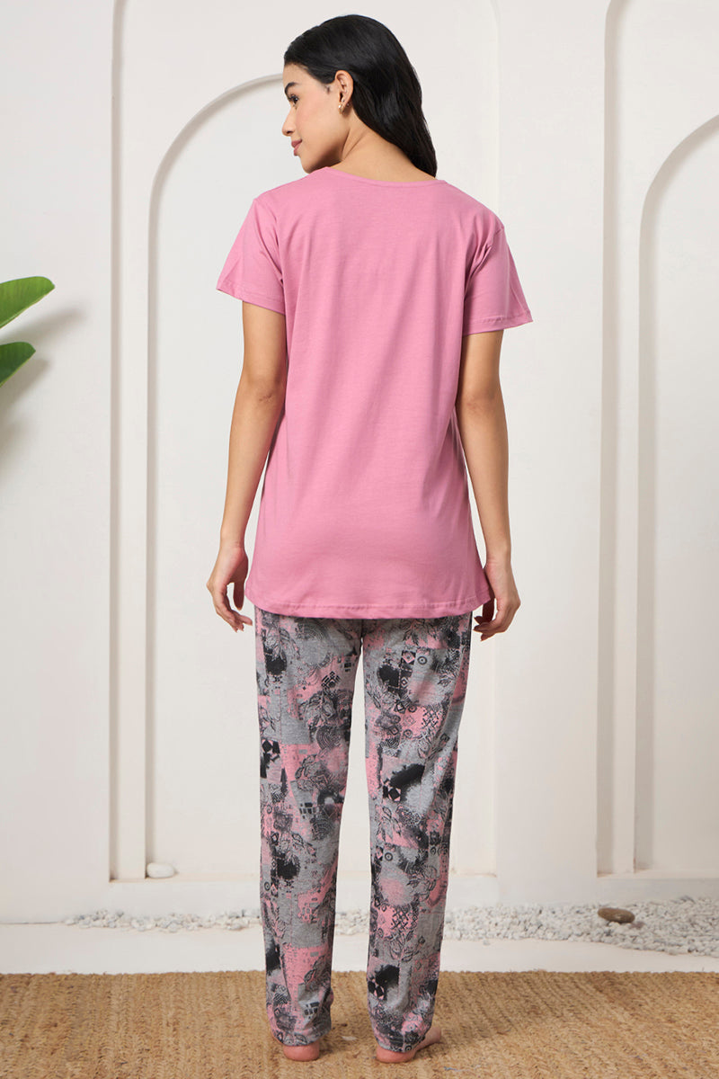 Back view of a woman wearing a pink tee and printed pyjama pants