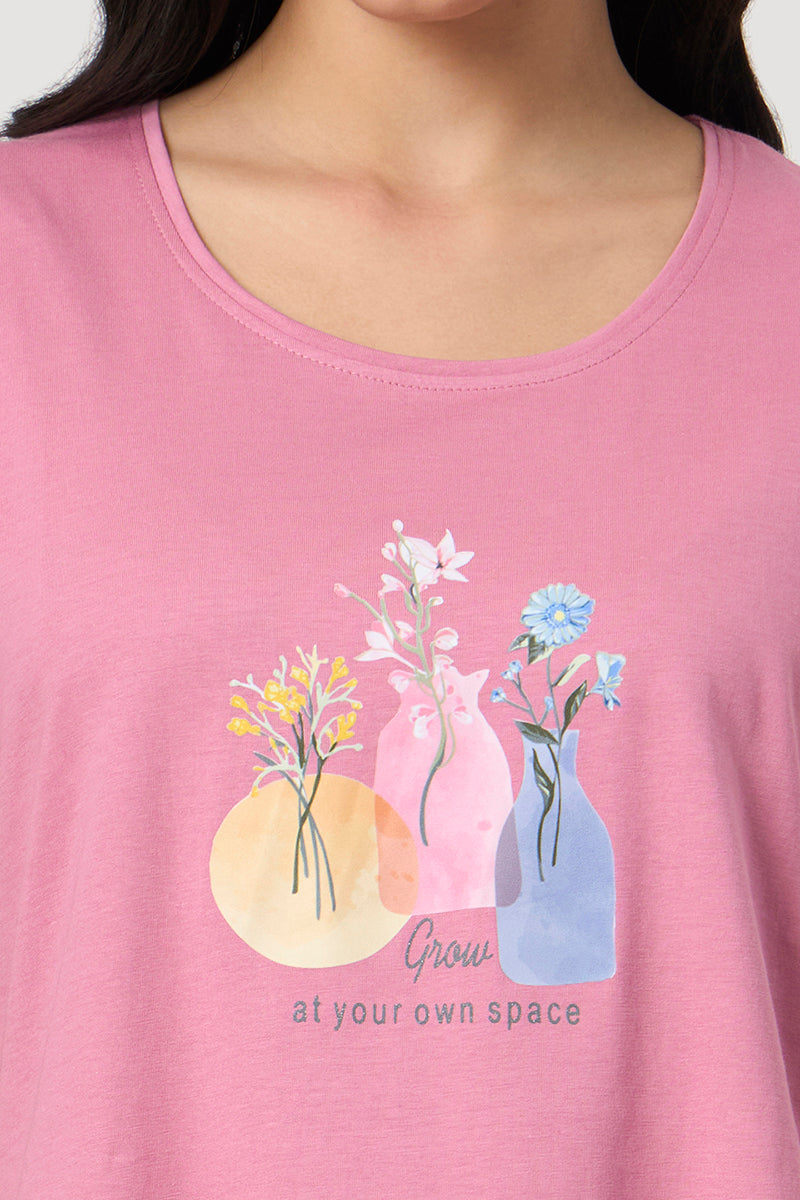 Close up of the floral vase print on the pink pyjama top