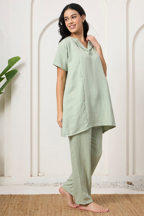 Woman standing sideways in a sage green tunic and pants co-ord set