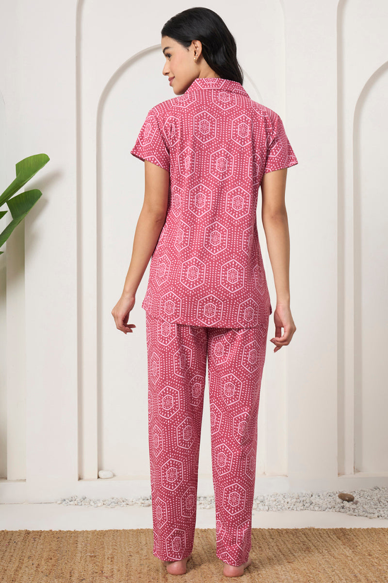 Back view of a woman wearing a pink bandhani print shirt and pants