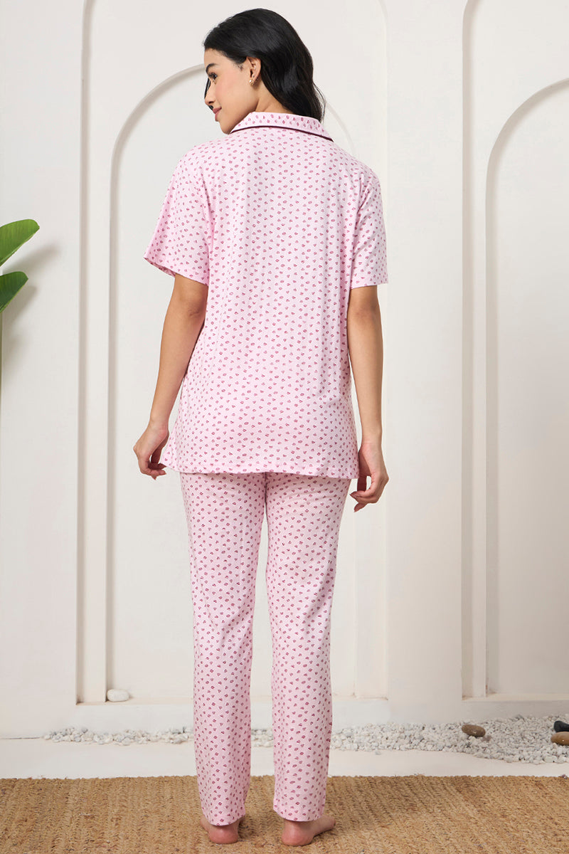 Back view of a woman wearing a pink printed shirt and pants set