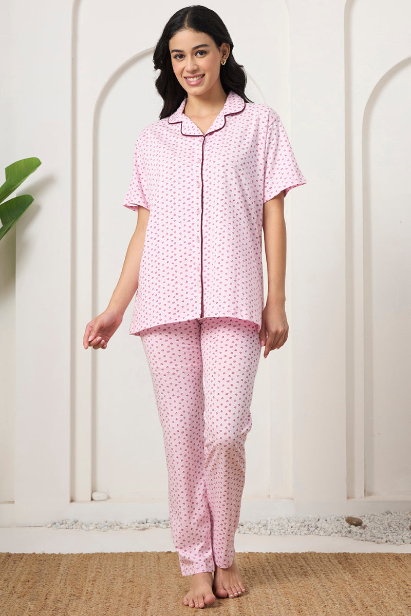 Woman standing in a pink printed notch collar shirt and pants set