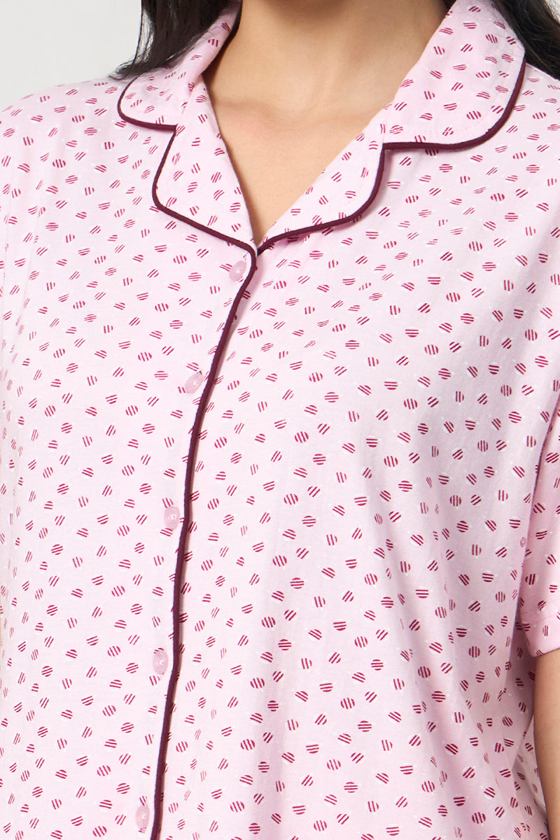 Close up of the notch collar and contrast piping on the pink shirt