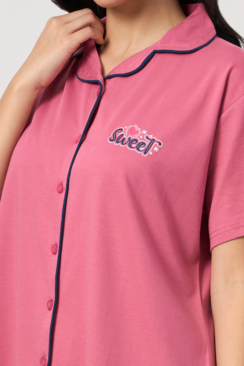 Close up of the sweet graphic embroidery on the pink shirt