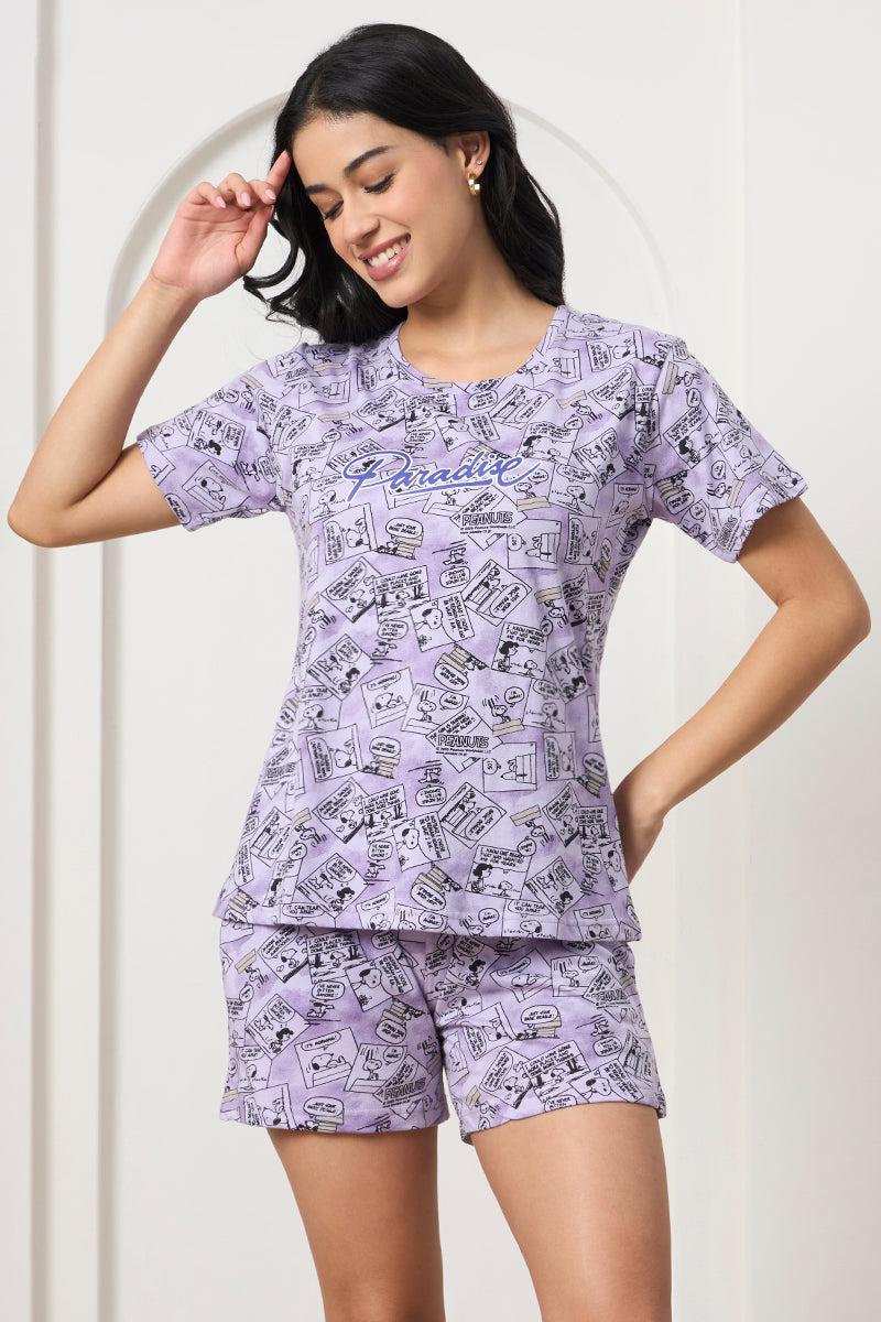 Woman posing with hand in hair, wearing a lilac printed co-ord set