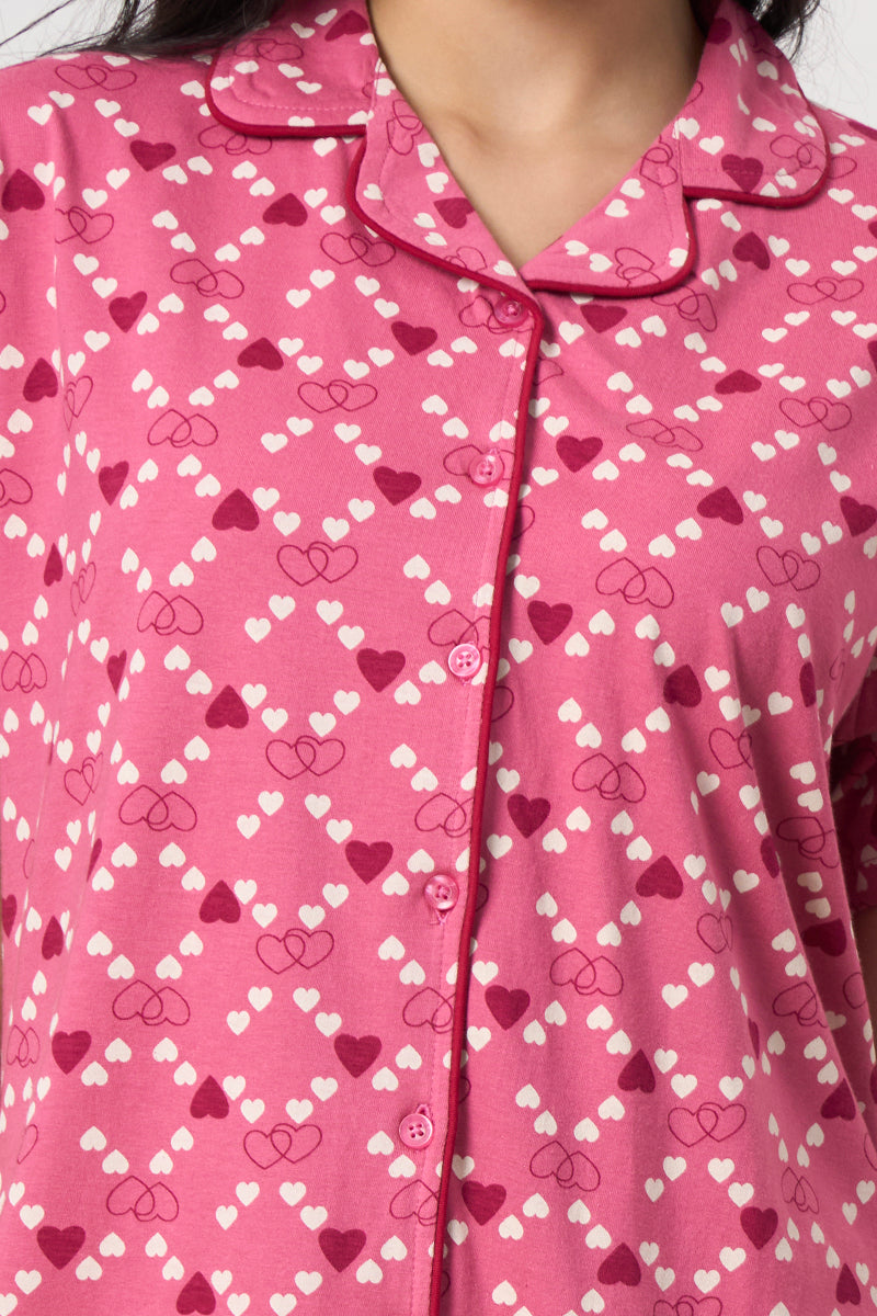 Close up of the notch collar and heart print detail on the pink shirt