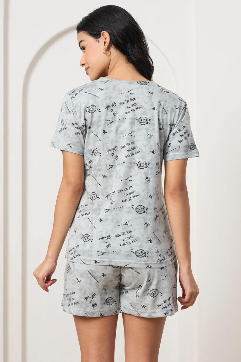 Back view of a woman wearing a grey printed t-shirt and shorts set