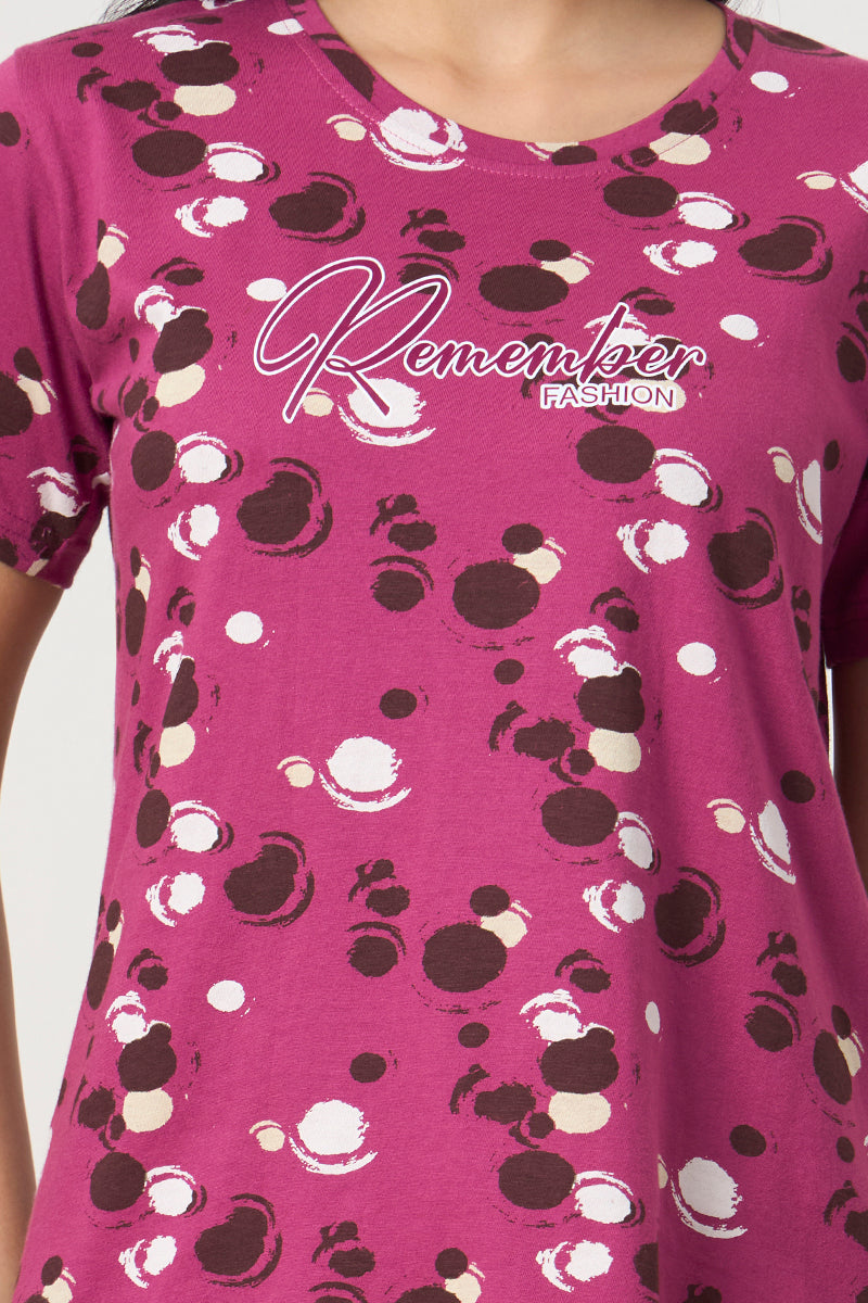 Close up of the polka dot print detail on the magenta t-shirt